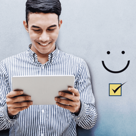 man smiling when holding a questionnaire